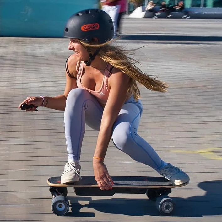 Female riding Meepo Mini V5 electric skateboard