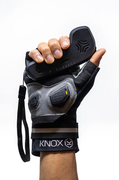 Front view of flatland fingerless glove holding a boosted remote plam side
