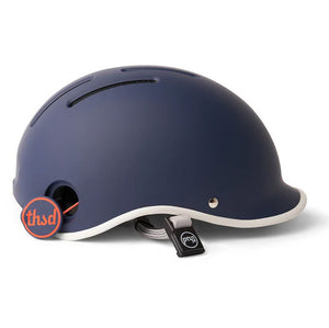 Navy blue Thousand helmet with orange poplock on a white backdrop.