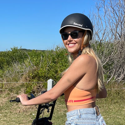 Blonde girl smiling with black Thousand Helmet on