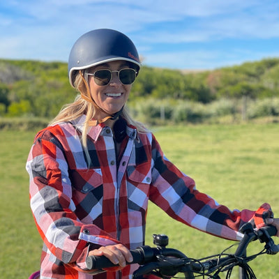 Girl wearing an armoured shirt on a bike