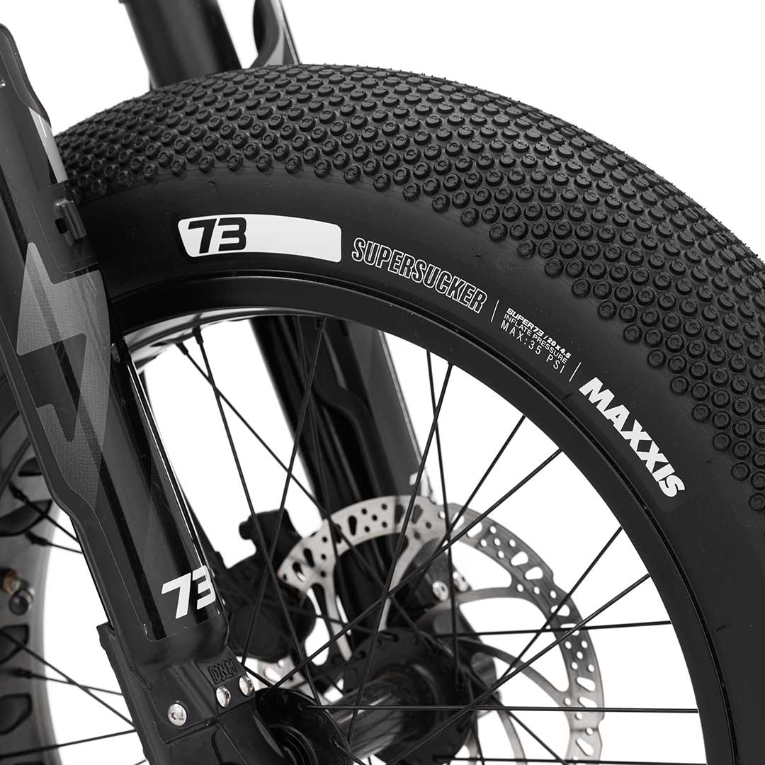 Side view of the MAXXIS SuperSucker tire pair (4.5" front and 5" rear), designed for extended-range commuting with superior traction on wet and dry roads.